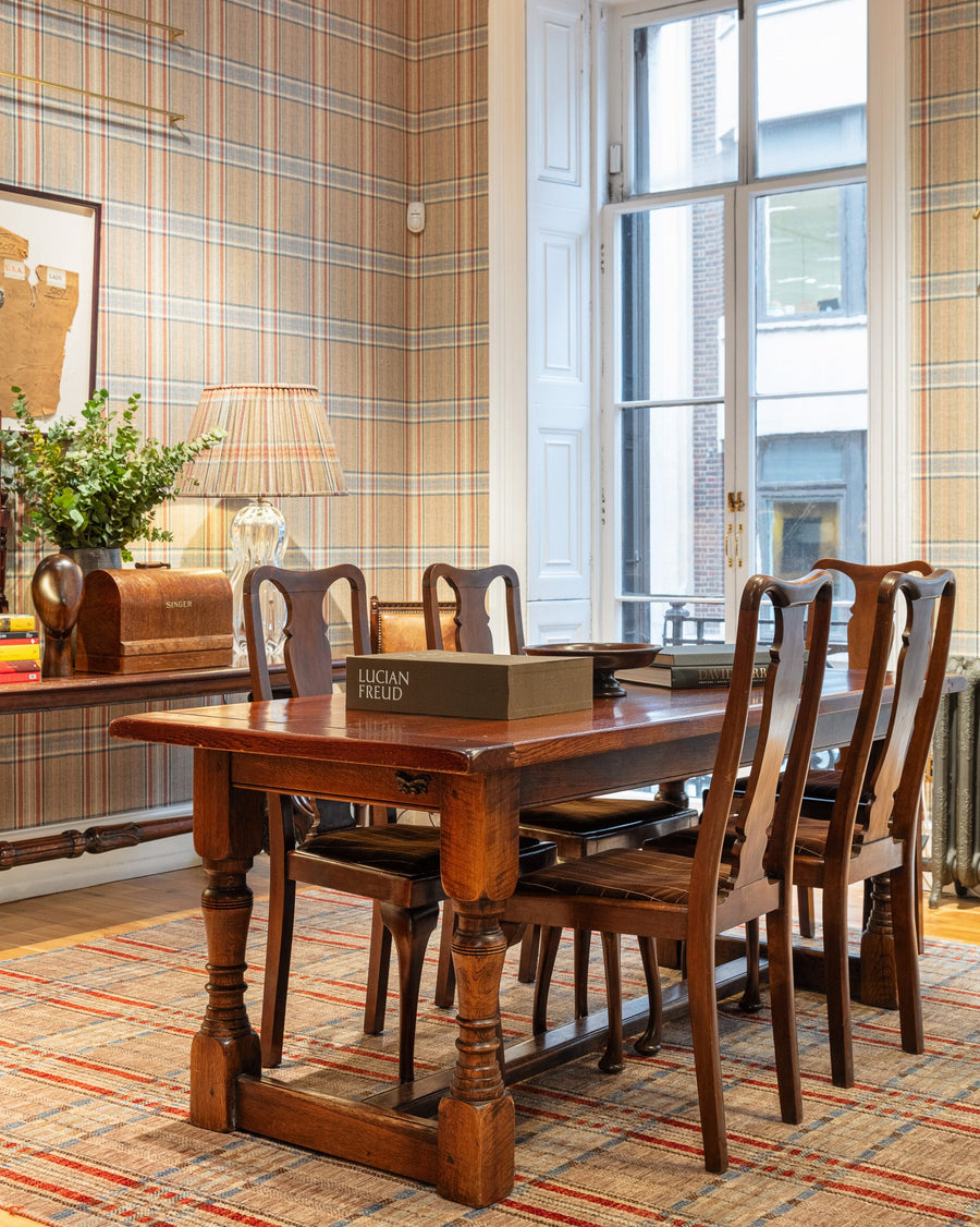 The Huntsman Club dining room at 11 Savile Row - dark mahogany table, Huntsman tweed wallpaper and French doors opening onto Savile Row