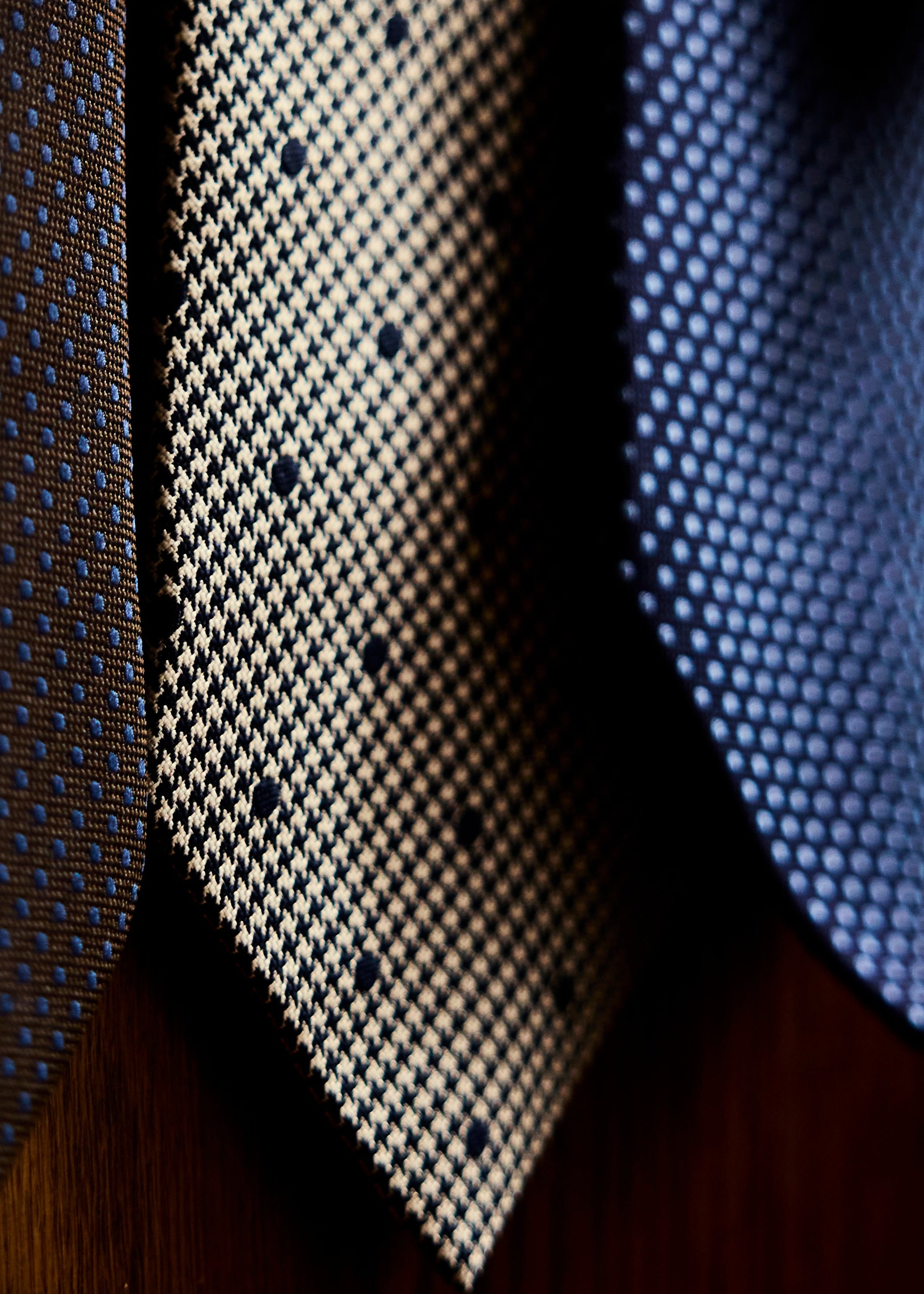 Close-up of patterned ties on a wooden surface