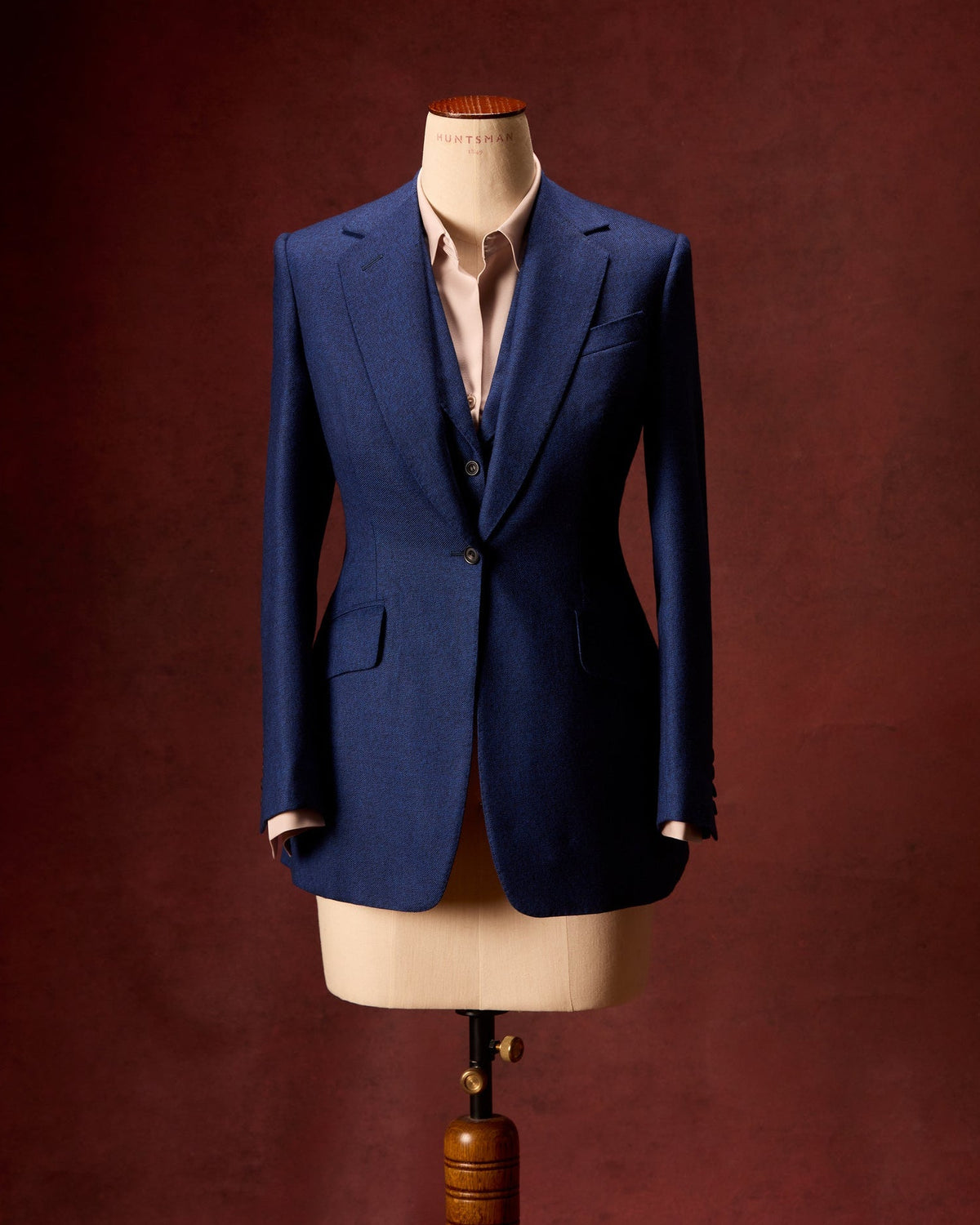 Huntsman ladies bespoke camel wool belted overcoat, detail view on mannequin.