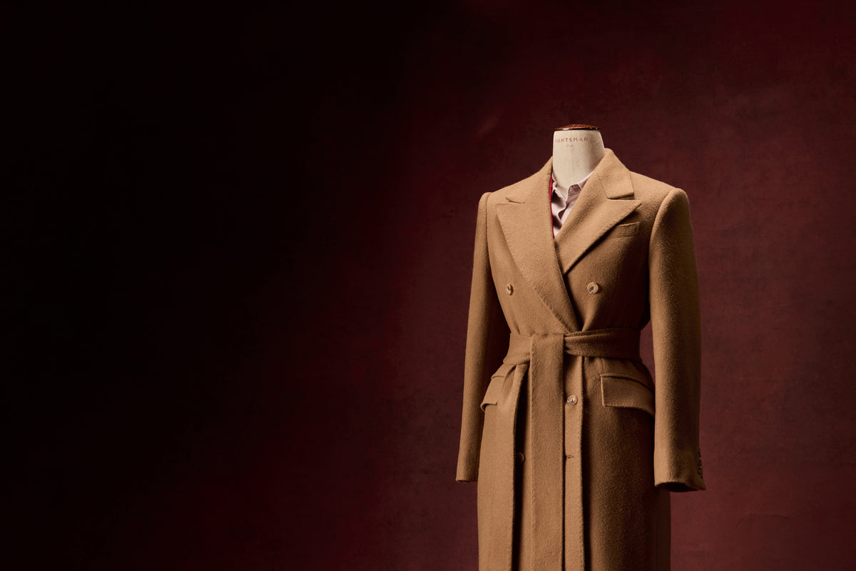 Huntsman ladies bespoke camel wool belted overcoat, detail view on mannequin.