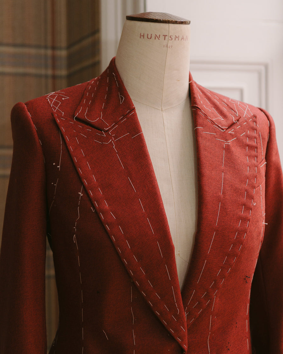 Huntsman bespoke women's red wool jacket at fin bar fin stage on a Huntsman mannequin at 11 Savile Row